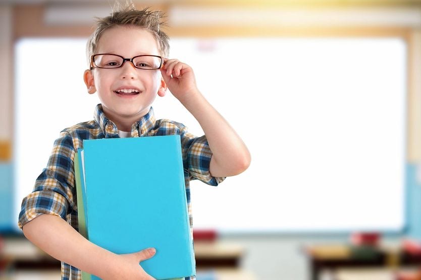 child in school with glasses