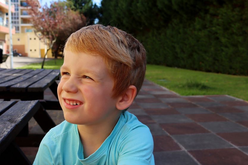 Common childhood vision problems young girl outside squinting