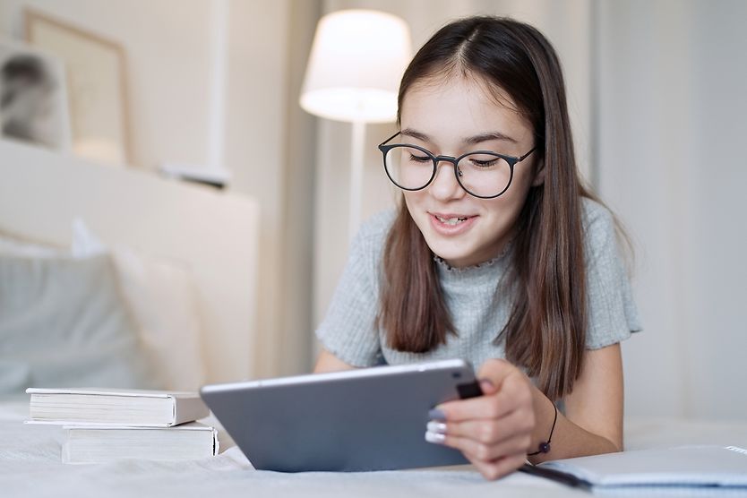Should you buy blue light glasses for your kids? a child using blue light glasses