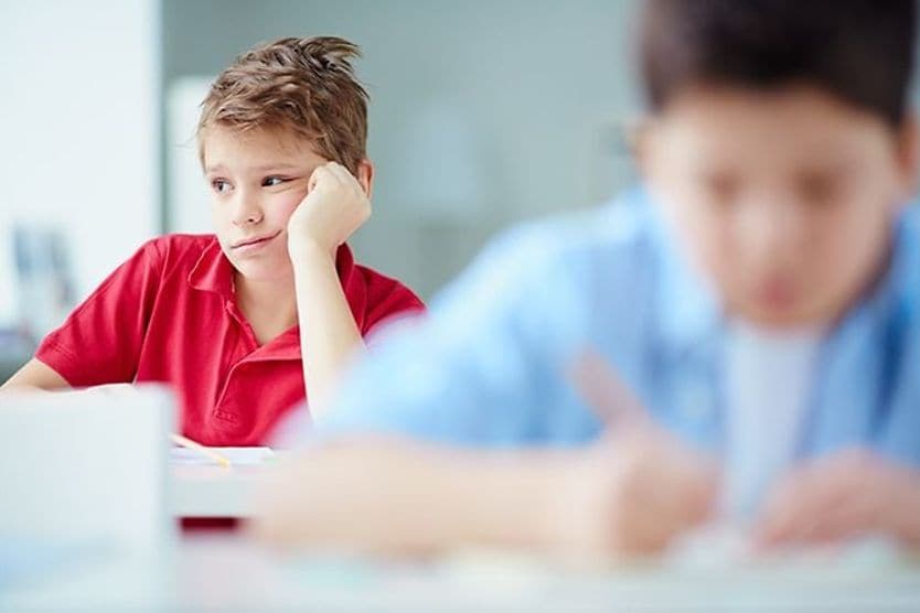 12 hidden signs your child may need glasses bored student in class
