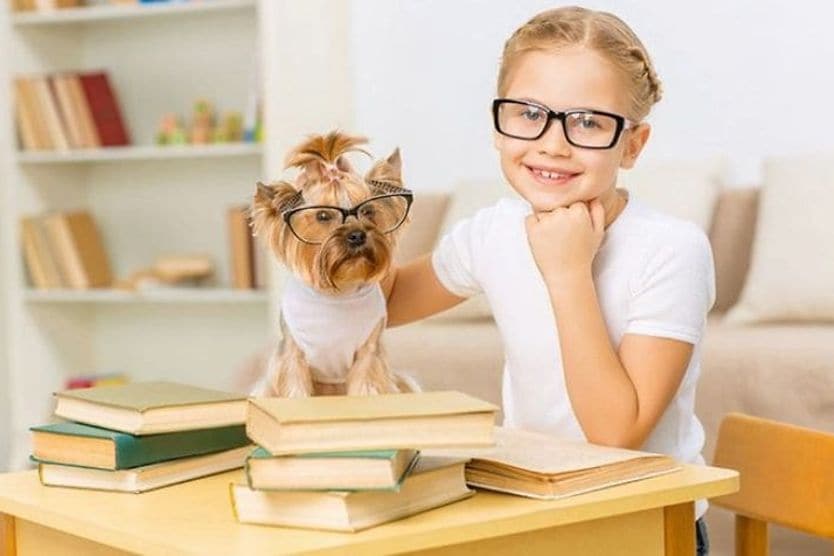 How you can improve your kid’s vision young girl wearing eyeglasses looking at her mobile phone