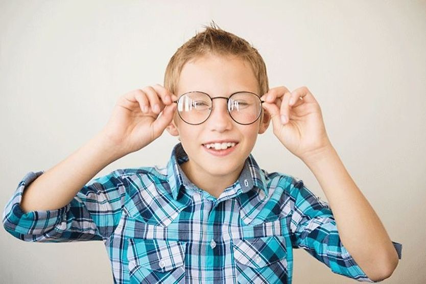 What to do when new glasses make your child’s vision blurry boy wearing glasses with blurry vision