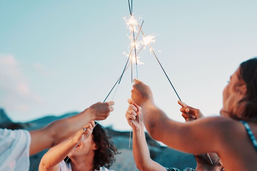 How to prevent eye injuries group of friends holding up sparklers to their faces