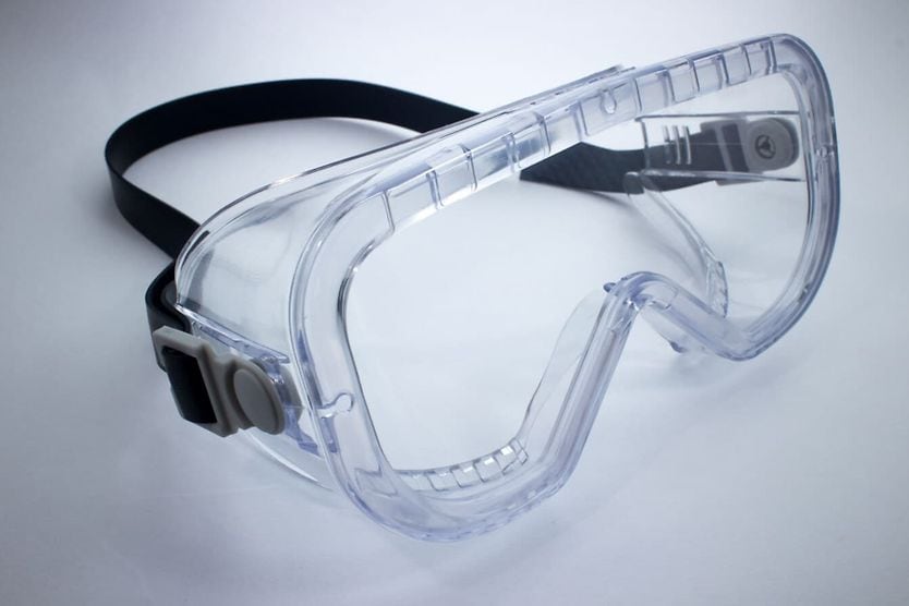 Safety glasses and protective eyewear man wearing polycarbonate lenses while working with tools