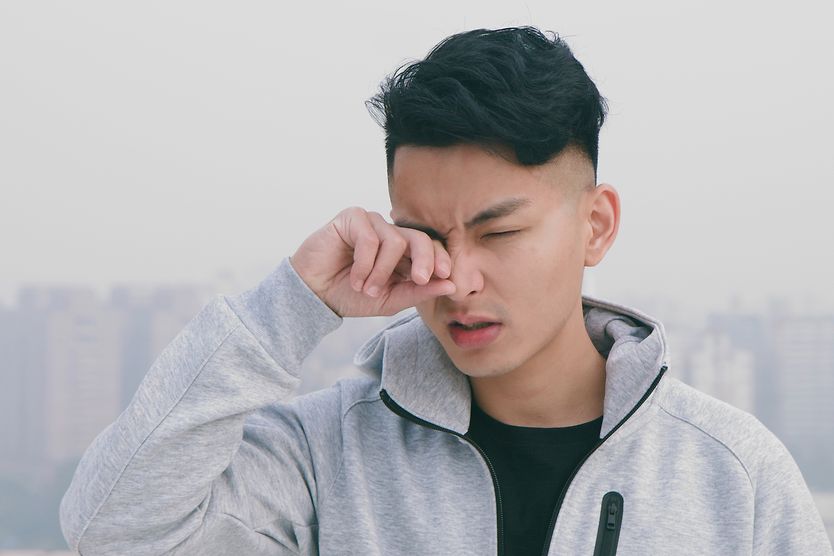 How climate, humidity and environmental factors may affect eyes and vision man with irritated eyes due to the poor climate and humidity
