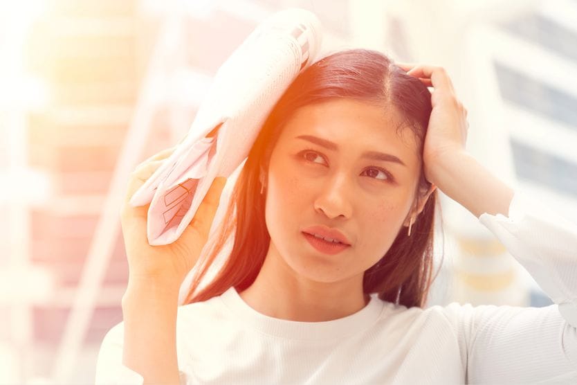 5 eye conditions linked to sun damage woman shielding her eyes from the sun