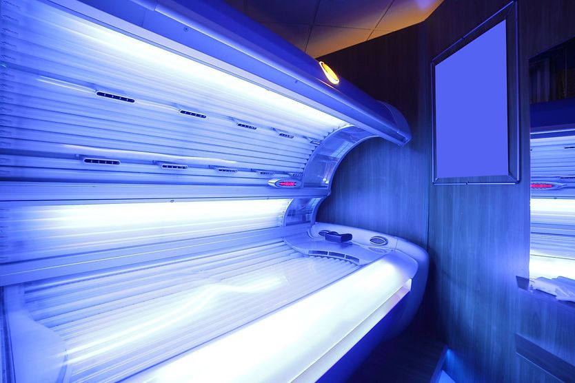 woman in tanning bed with uv light