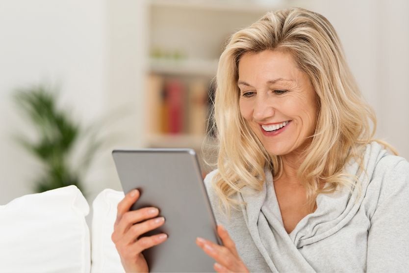 What are bifocal contact lenses for astigmatism? middle aged woman reading digital tablet