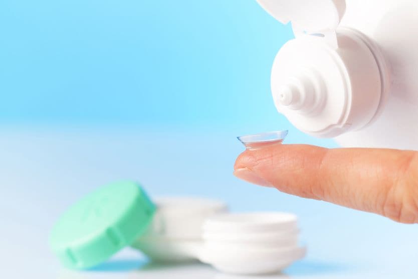 Caring for gas permeable contact lenses cleaning a contact lens