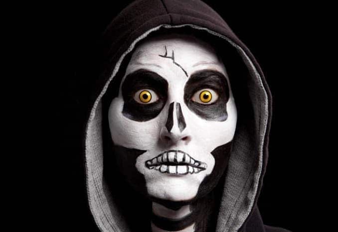 woman in halloween costume with specialty contact lenses