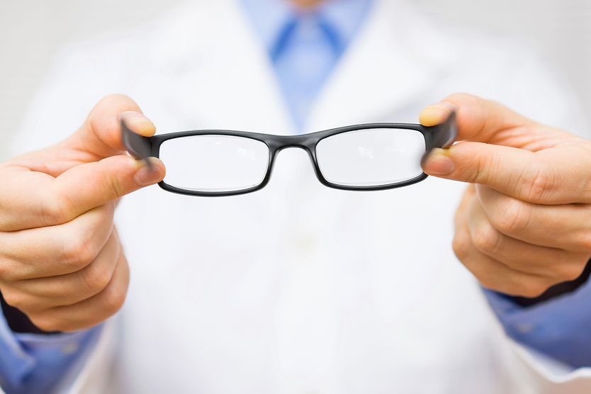 optometrist giving new eyeglasses