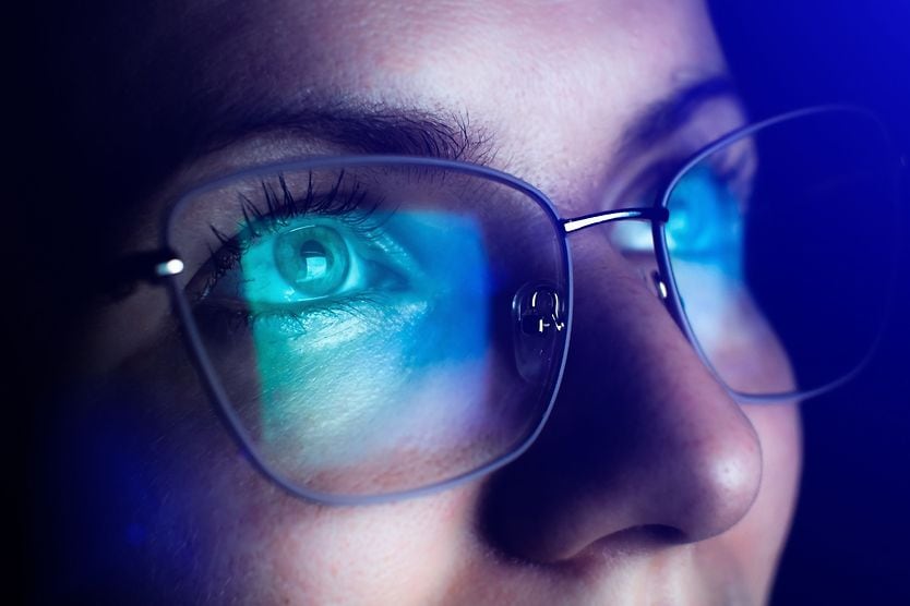 How to find the best computer glasses in 2026 man wearing eyeglasses with computer screen in reflection of eyeglass lenses