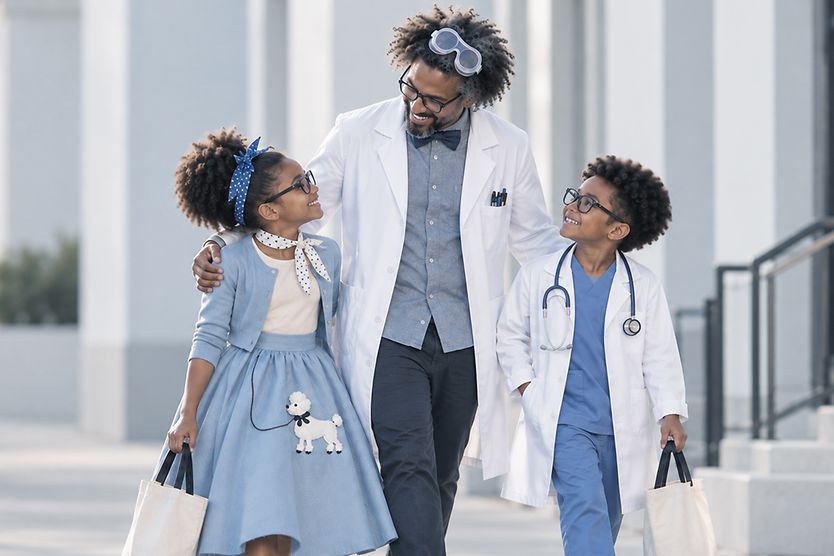 Halloween costumes for glasses wearers Family walking down the street in Halloween costumes.