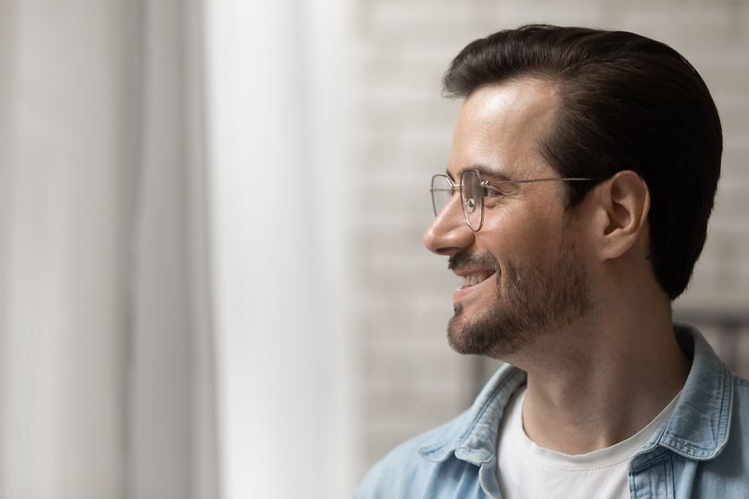 High-index lenses: Transform thick glasses to thin glasses hand wearing glasses turned sideways