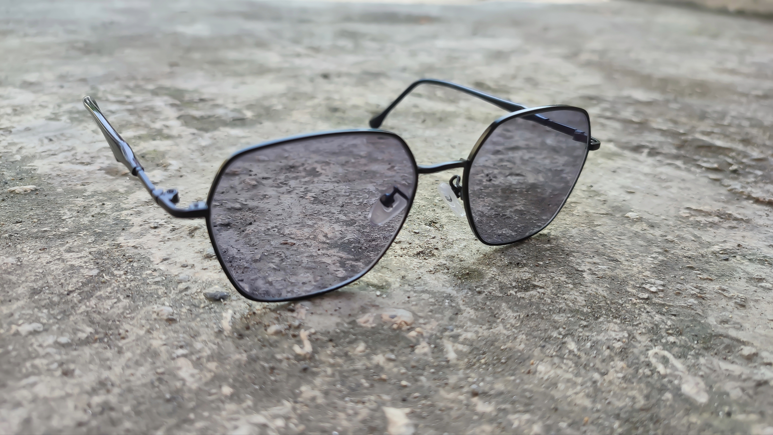 Photochromic lenses on concrete.