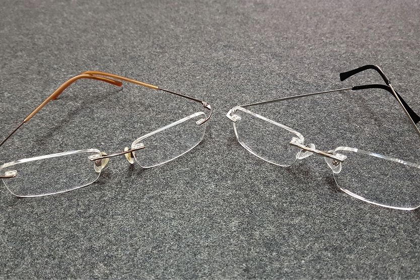 Plastic vs. Polycarbonate Lenses: Advantages & Disadvantages Two sets of glasses sitting on a counter.