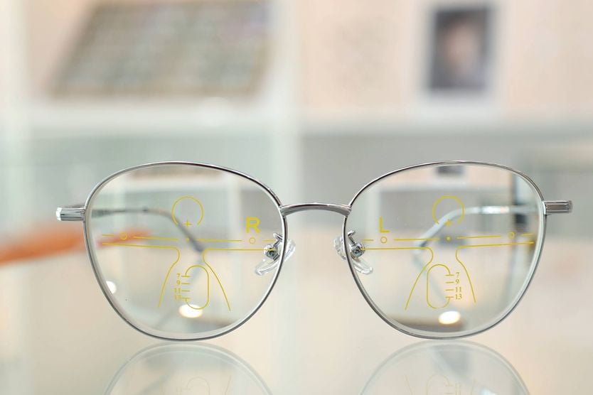 Progressive glasses for clear vision at all distances Progressive glasses with lens markings illustrating seamless vision correction for near and distance viewing.