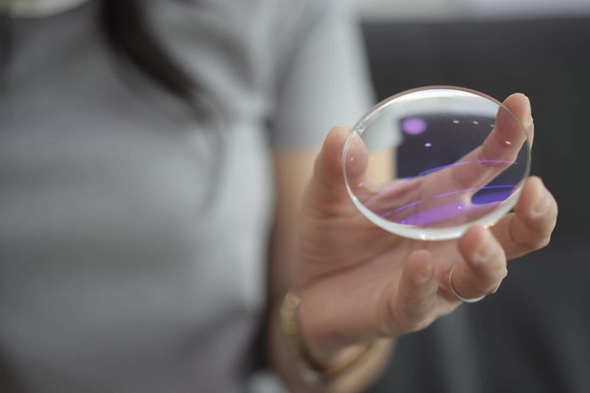 High-definition eyeglass lenses woman holding eyeglass lens