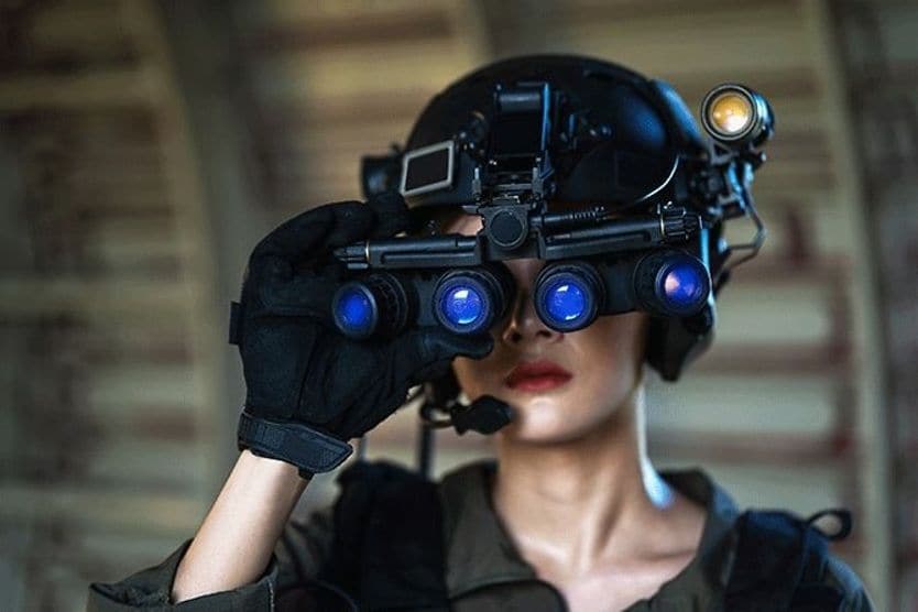 Night vision goggles and binoculars woman wearing night vision goggles and binoculars