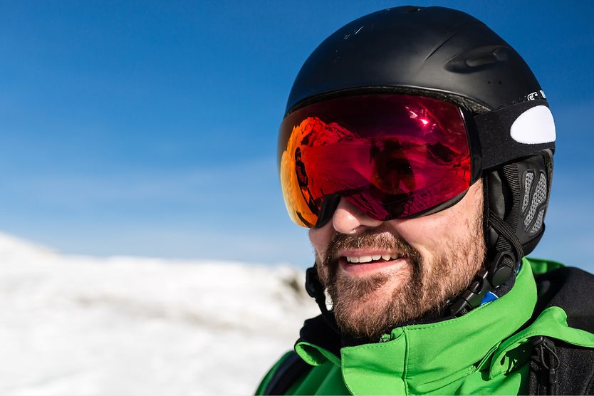 Ski goggles: A buyer's guide for skiers and snowboarders man wearing ski goggles