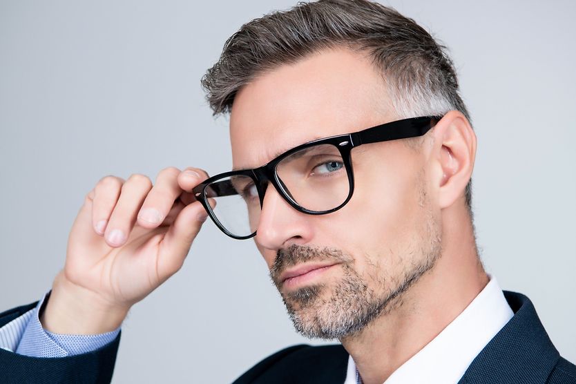 Spy glasses: All you need to know man in suit putting on his spy glasses