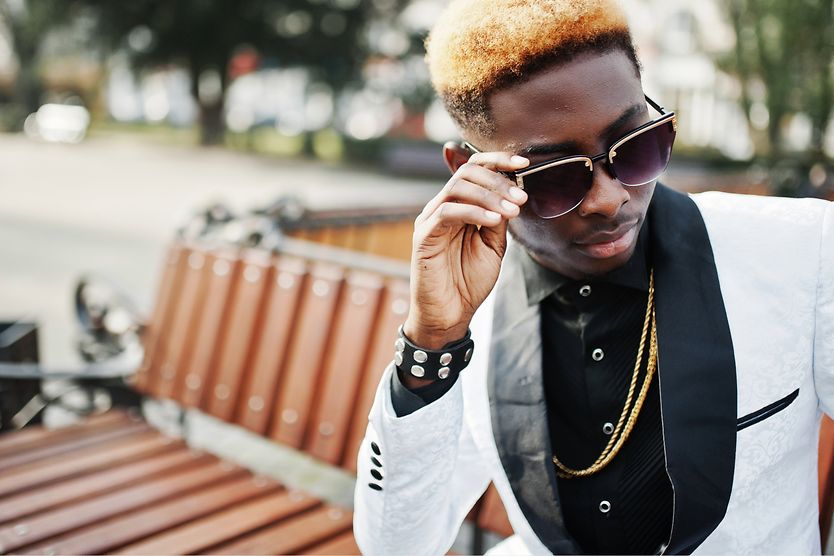 Designer shades: Are they really worth it? African American male wearing designer sunglasses