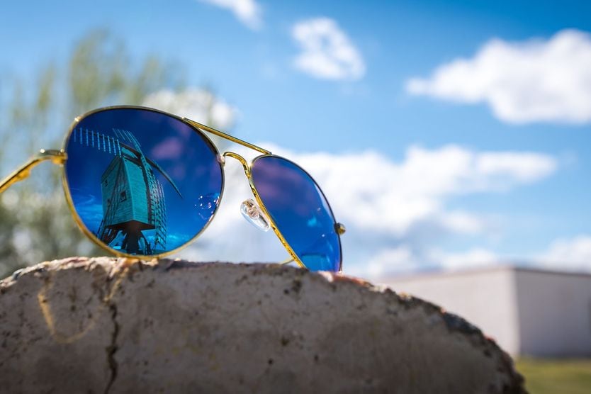 How should your Aviator sunglasses fit? Blue-tinted Aviator sunglasses.