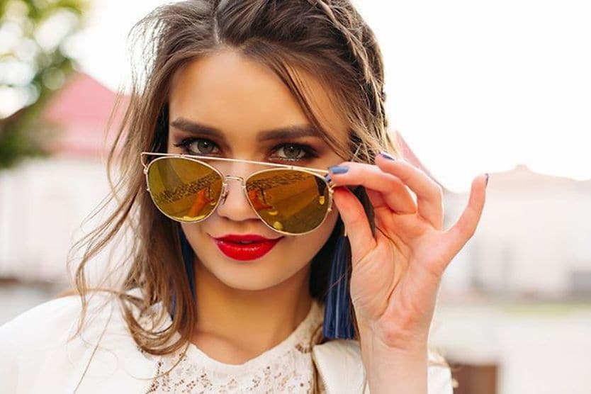 Sunglasses for round faces Woman peering over her sunglasses