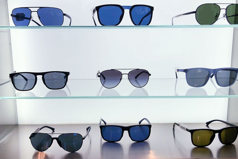 What sunglass frame materials are hypoallergenic? Assortment of sunglasses in a store.