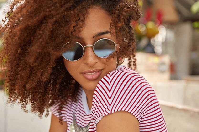 The latest trends for round sunglasses in 2024 woman wearing round sunglasses outside