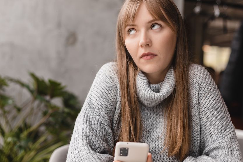 Why do people roll their eyes? woman rolling his eyes while holding phone