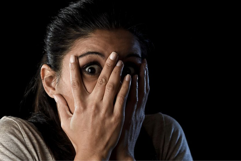 Ommetaphobia: The fear of eyes person with ommetaphobia covering one of their eyes with their hands