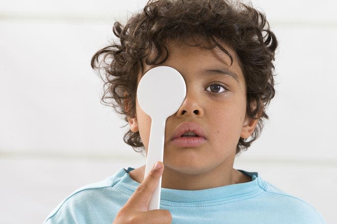 young boy getting vision test