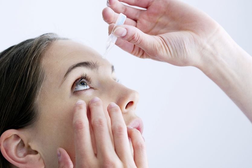 Erythromycin eye ointment: Uses, side effects and more woman inserting erythromycin ointment into her eye
