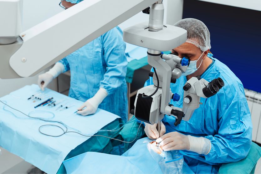 An eye surgeon performing cataract surgery on a patient. An eye surgeon performing cataract surgery on a patient.