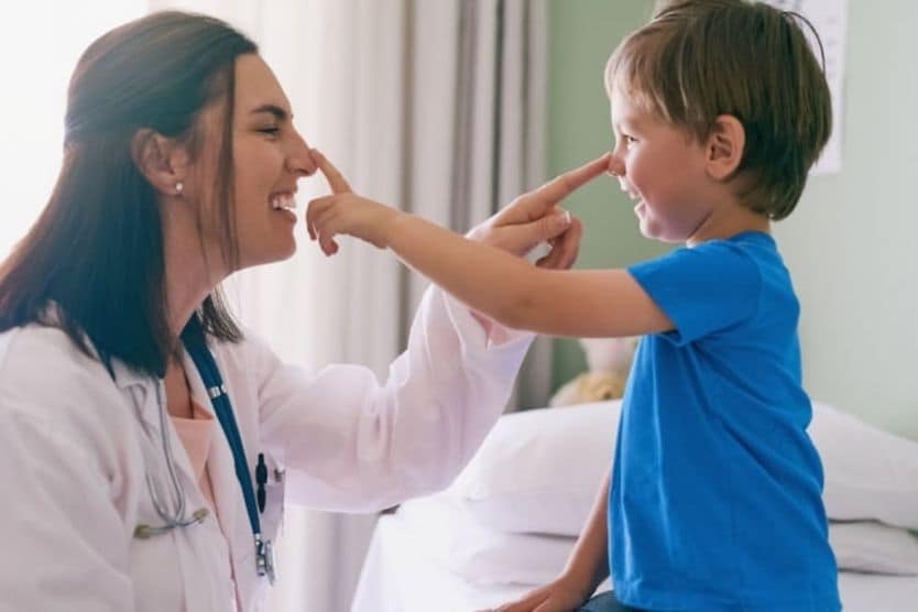 Female eye doctor and little boy