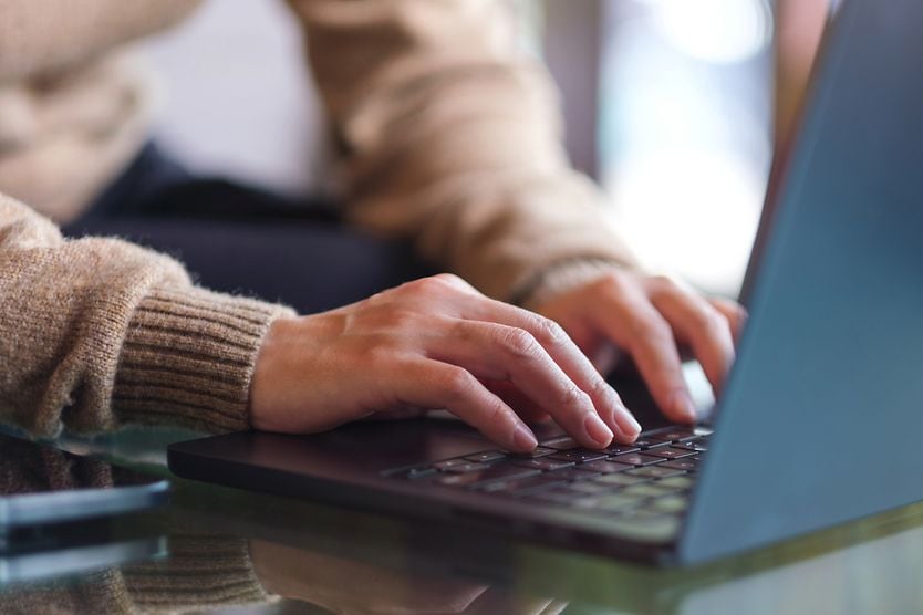 man typing on laptop