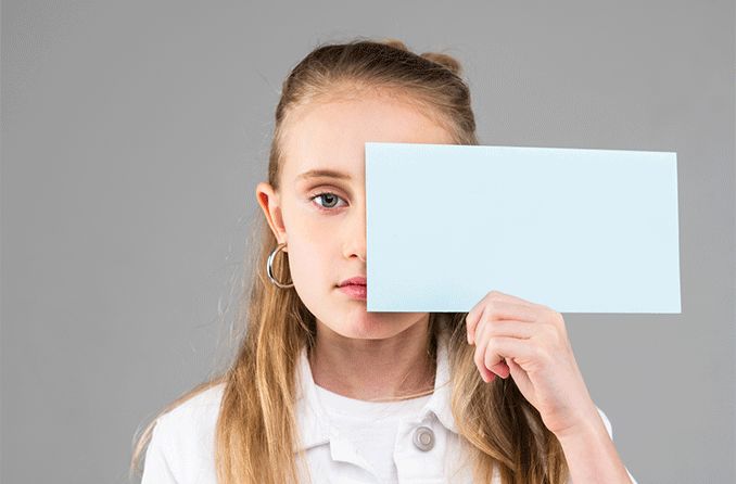 girl with nystagmus covering one eye