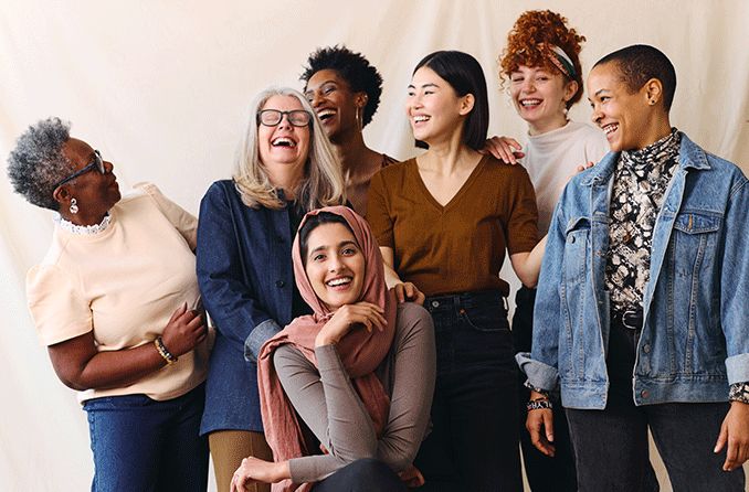 group of women of all ages laughing and smiling