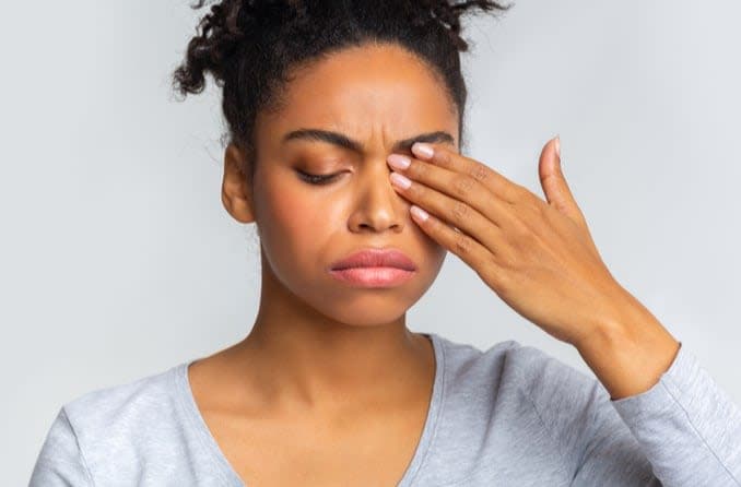 Woman with eyes closed from eye discomfort