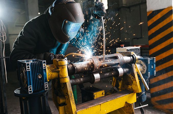 Welder wearing face and eye protection