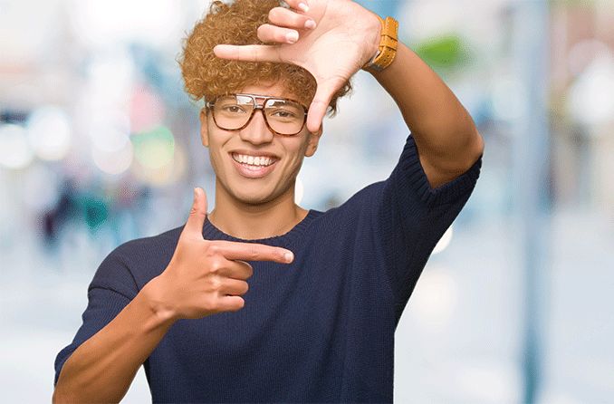 man framing his face shape with his fingers