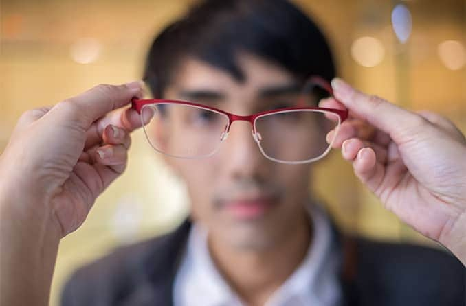 putting eyeglasses on a man with astigmatism