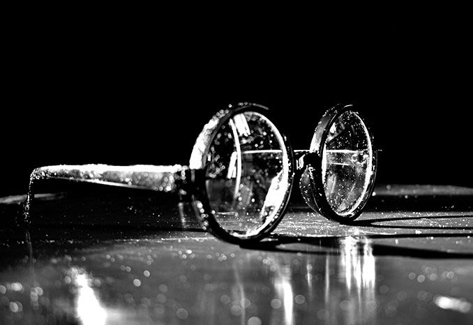 dusty old pair of eyeglasses in black and white