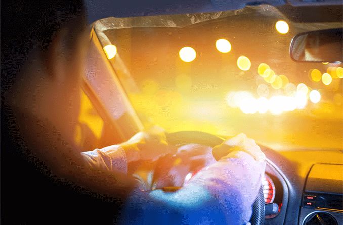 man driving at night seeing halos around lights