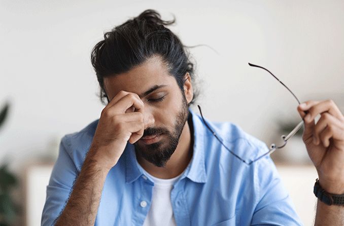 man feeling pressure behind his eyes