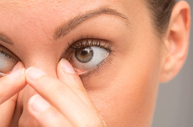 woman wiping away her eye boogers