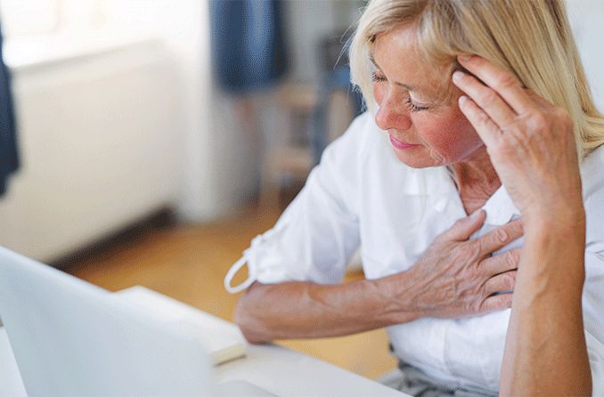 woman with eye twitching wondering if it's a sign of a stroke touching her temple and chest