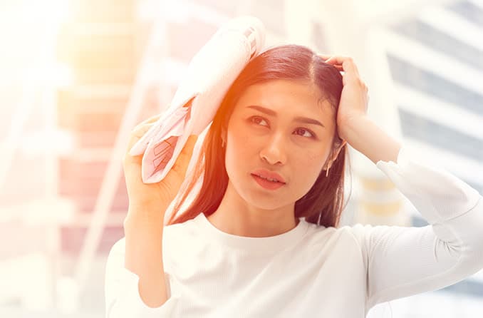 woman shielding her eyes from the sun