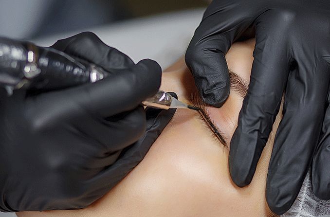 closeup of an eye getting a permanent eyeliner tattoo